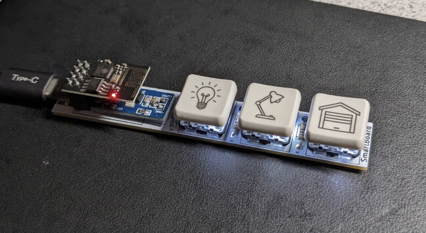 The three keycaps etched with lightbulb, lamp and garage door icons for their controls